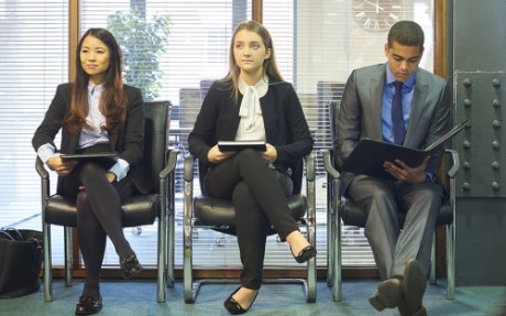Photo: Three people waiting for job interview.