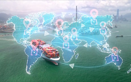 Image of international map over a picture of cargo ships in a port.