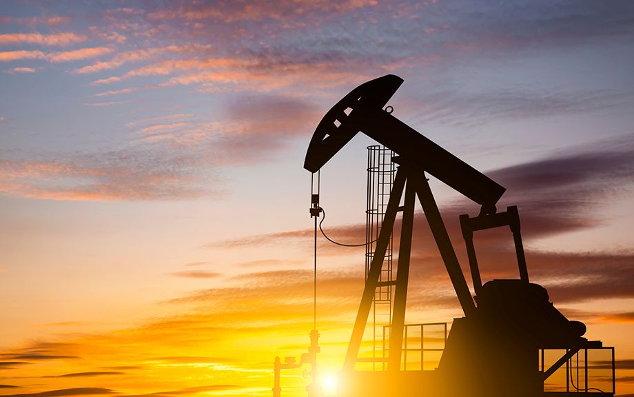 Photo: Oil pump on a sunset background. World Oil Industry