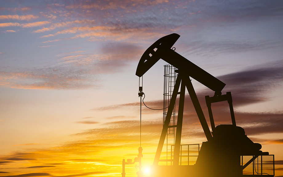 Photo: Oil pump on a sunset background. World Oil Industry