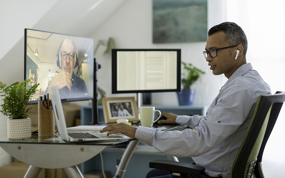 photo decorative: Businessman checking emails while on a video call from his home office