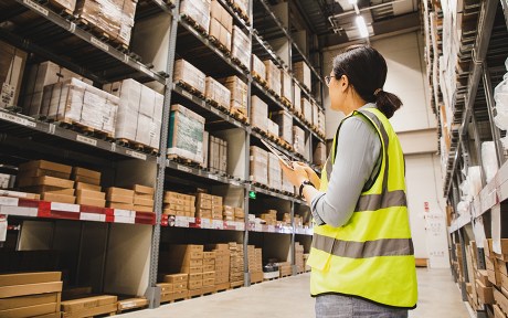 Photo: asian businesswoman holding a digital tablet working at a warehouse