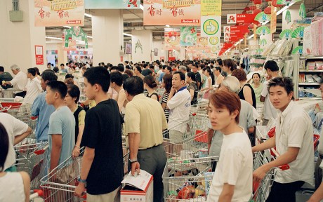Photo: Chinese shoppers lining up to buy shopping carts full of items within a store