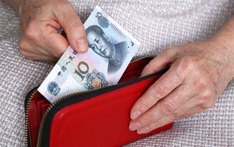 Photo: decorative: Concept of pension payments in China, savings at retirement, pensioner with money