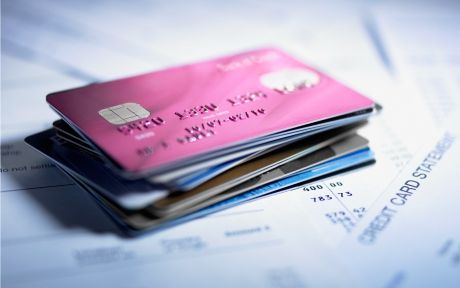 Decorative: photo of stack of credit cards on credit card statements