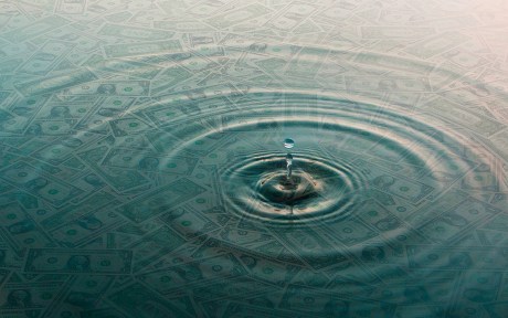 Decorative photo: dollar bills and ripples and drop of water over them