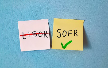 Photo of two sticky notes: one with LIbor crossed out, the other with SOFR checked. Concept of London Interbank Offered Rate being discontinued and succeeded by SOFR - Secured Overnight Financing Rate - as the base rate for loan and swap financial products.
