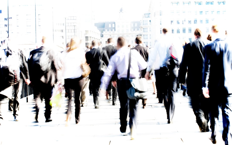 Decorative photo: workers walking on city street during rush hour