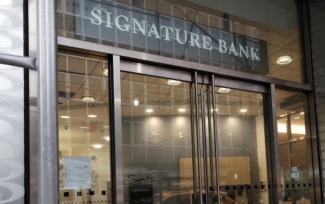  outside doors of Signature Bank building with bank name over the doors.