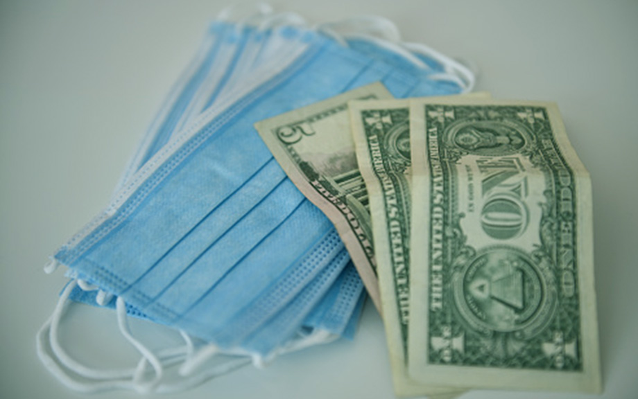 Decorative: U.S. dollars and surgical masks in a still life.