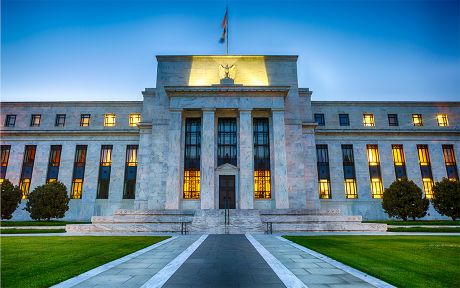 Federal reserve building Washington DC lit up at twilight.