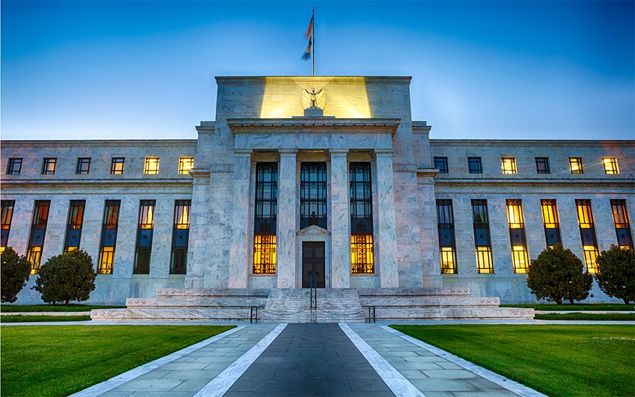 Federal reserve building Washington DC lit up at twilight.