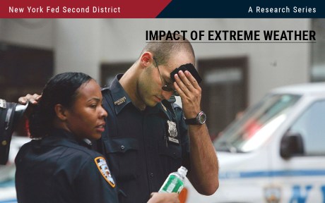 Photo: Two New York City police officers standing on a city street with police vehicle behind them. One is wiping his sweating brow, the other is holding a bottle of water.