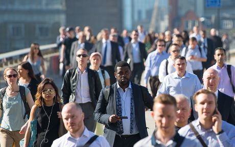 Photo of a crowd of business people and others walking to work.