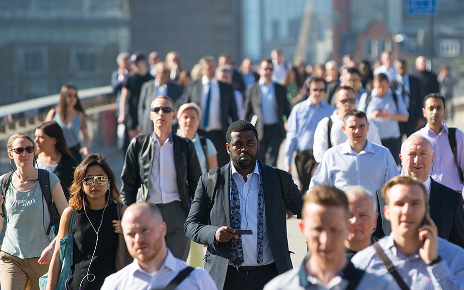 Photo of a crowd of business people and others walking to work.