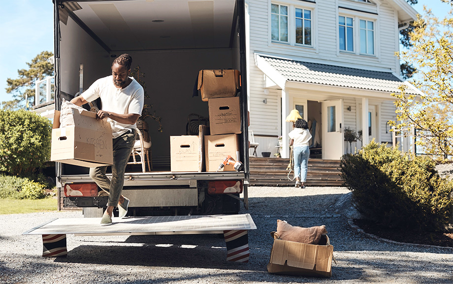 Photo: man unloading boxes from a moving truck