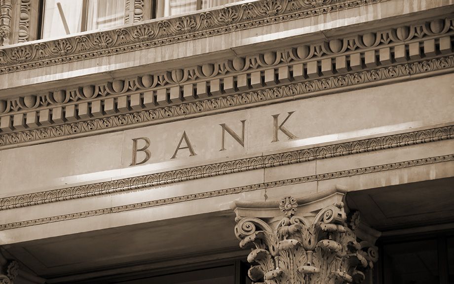 Photo of old bank building with columns.