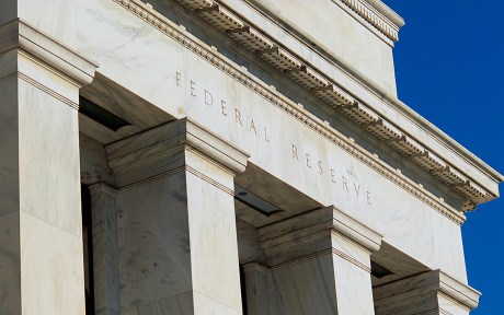 Close up photo of the Federal Reserve building's name carved in the stone at the top of the pillars.