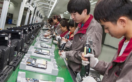 Photo: Workers assembly of notebook computer at a factory in Hefei city,Anhui Province,China.