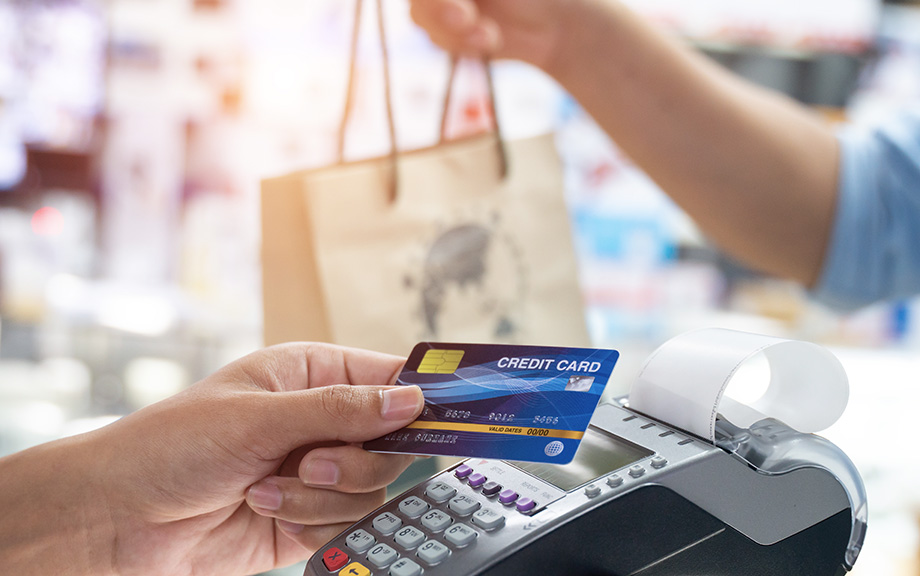 Decorative image: Close up of a card payment being made between a man and a waiter in a cafe.