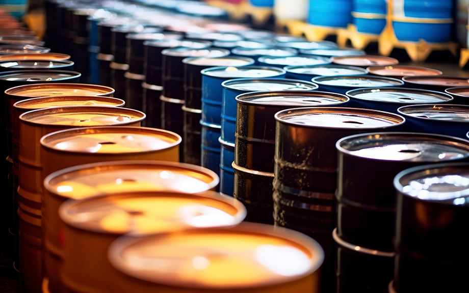Photo illustration of oil barrels stored in a warehouse. AI generated.