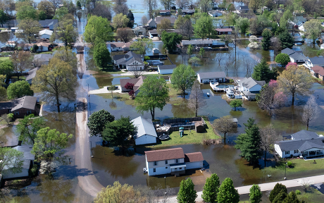 An aerial view shows floodwater surrounding homes on April 07, 2025 in East Prairie, Missouri. Thunderstorms, heavy rains, high winds and tornadoes have plagued the region for the past several days, causing widespread damage before moving east. (Photo by Scott Olson/Getty Images)