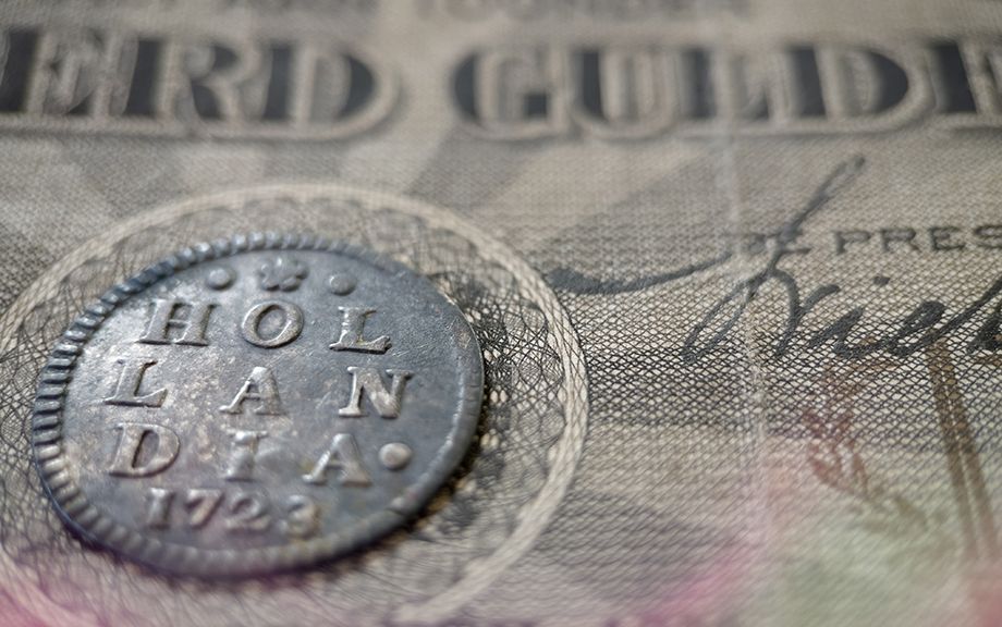 Photo: Old Dutch coins from the province of Holland with ancient Dutch banknotes.