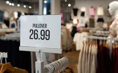 Price tag on a clothes rack with the inscription Pullover, Sweater 26.99