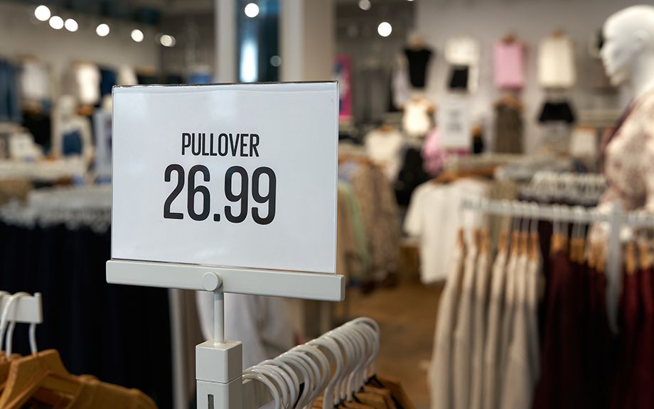 Price tag on a clothes rack with the inscription Pullover, Sweater 26.99