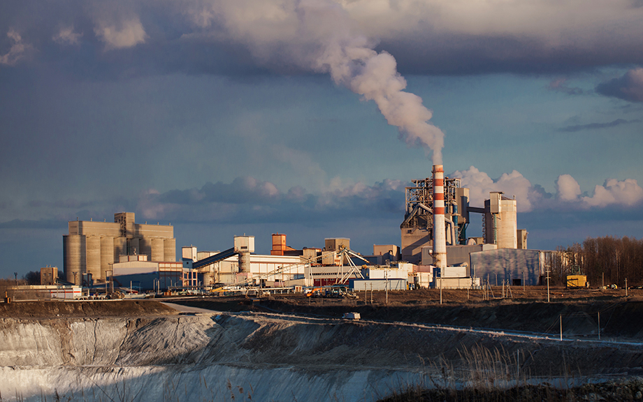 cement factory and chalk quarry against the sky with clouds