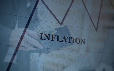 Photo: Man's hand holding a wallet, with Inflation text and line chart overlay