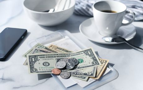 Image of a cafe receipt with U.S. money on top to pay the bill.