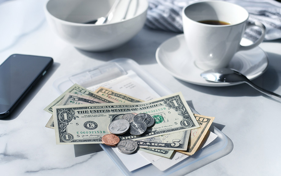 Image of a cafe receipt with U.S. money on top to pay the bill.