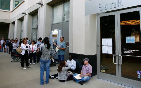 Photo of a long line of customers waiting to get into a Bank, open for the first time since the federal government takeover due to the bank's subprime mortgages with people with bad or no credit history.