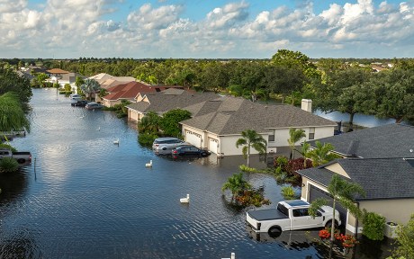 Hurricane Debby tropical rainstorm flooded residential homes and cars in suburban community in Sarasota, Florida. Aftermath of natural disaster.