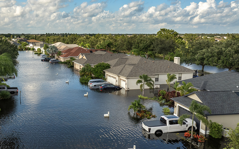 Hurricane Debby tropical rainstorm flooded residential homes and cars in suburban community in Sarasota, Florida. Aftermath of natural disaster.