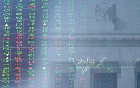 Decorative image of stock price board superimposed on the Federal Reserve building in Washington, D.C.