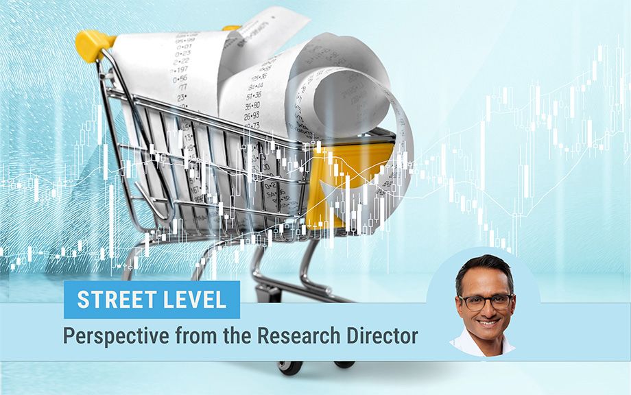 descriptive image of a toy shopping cart filled with receipts on a turquoise background. photo of research director Kartik Athreya on the bottom of the image.